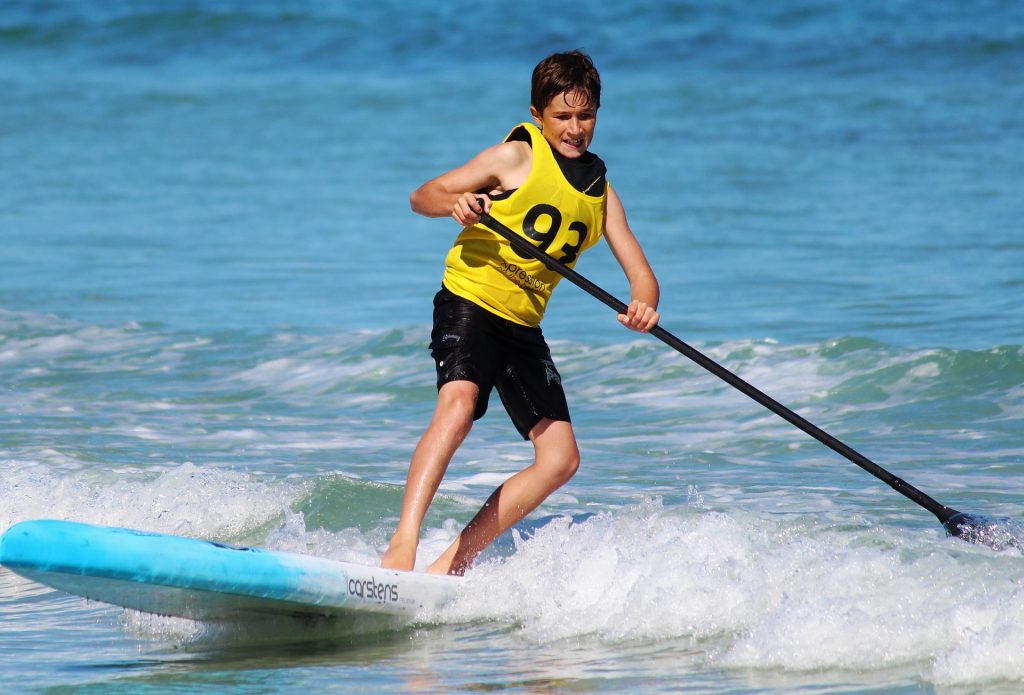 Photo of boy on a stand up paddle board